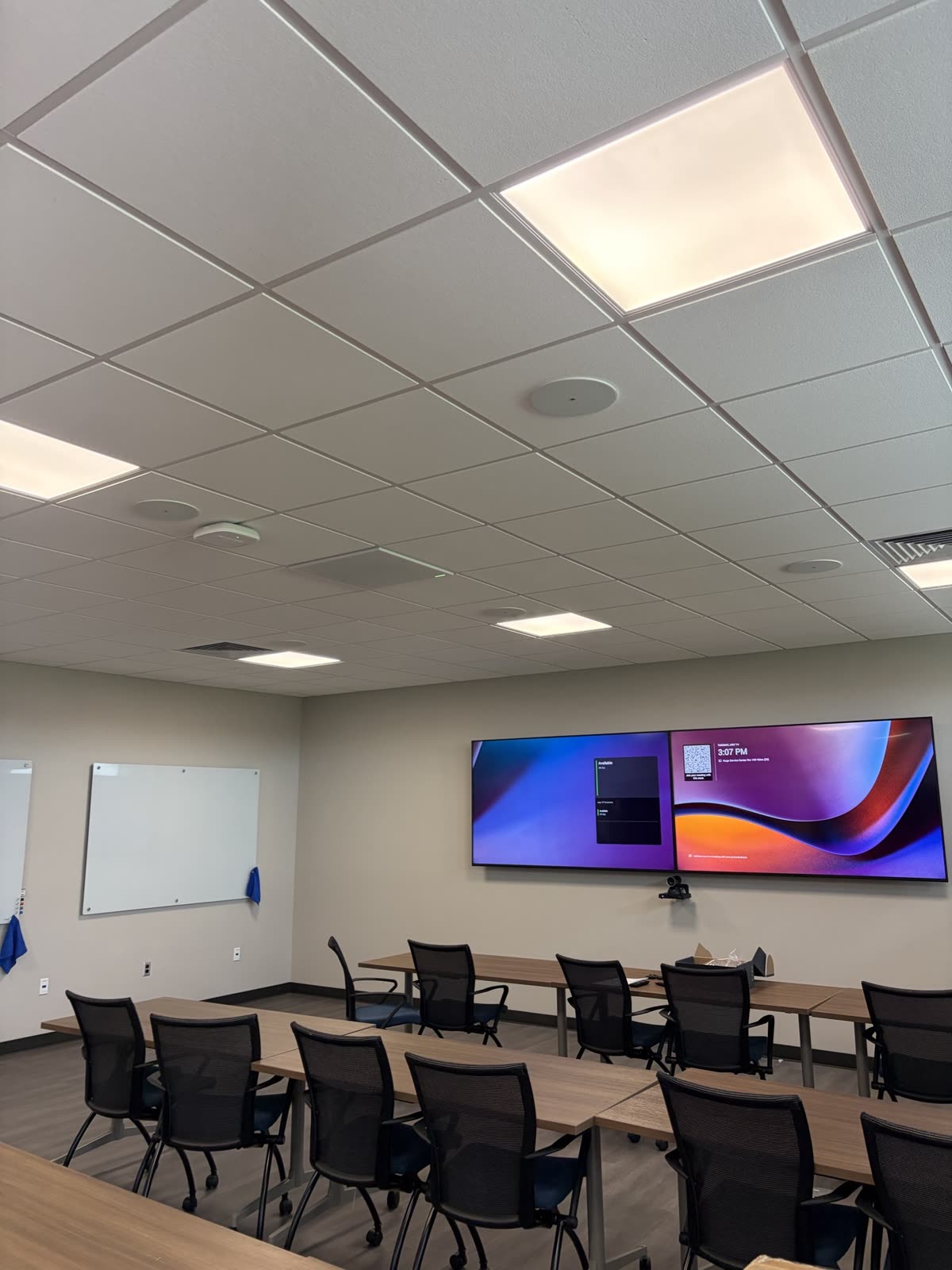 Finished training room with dual wall displays and a video camera