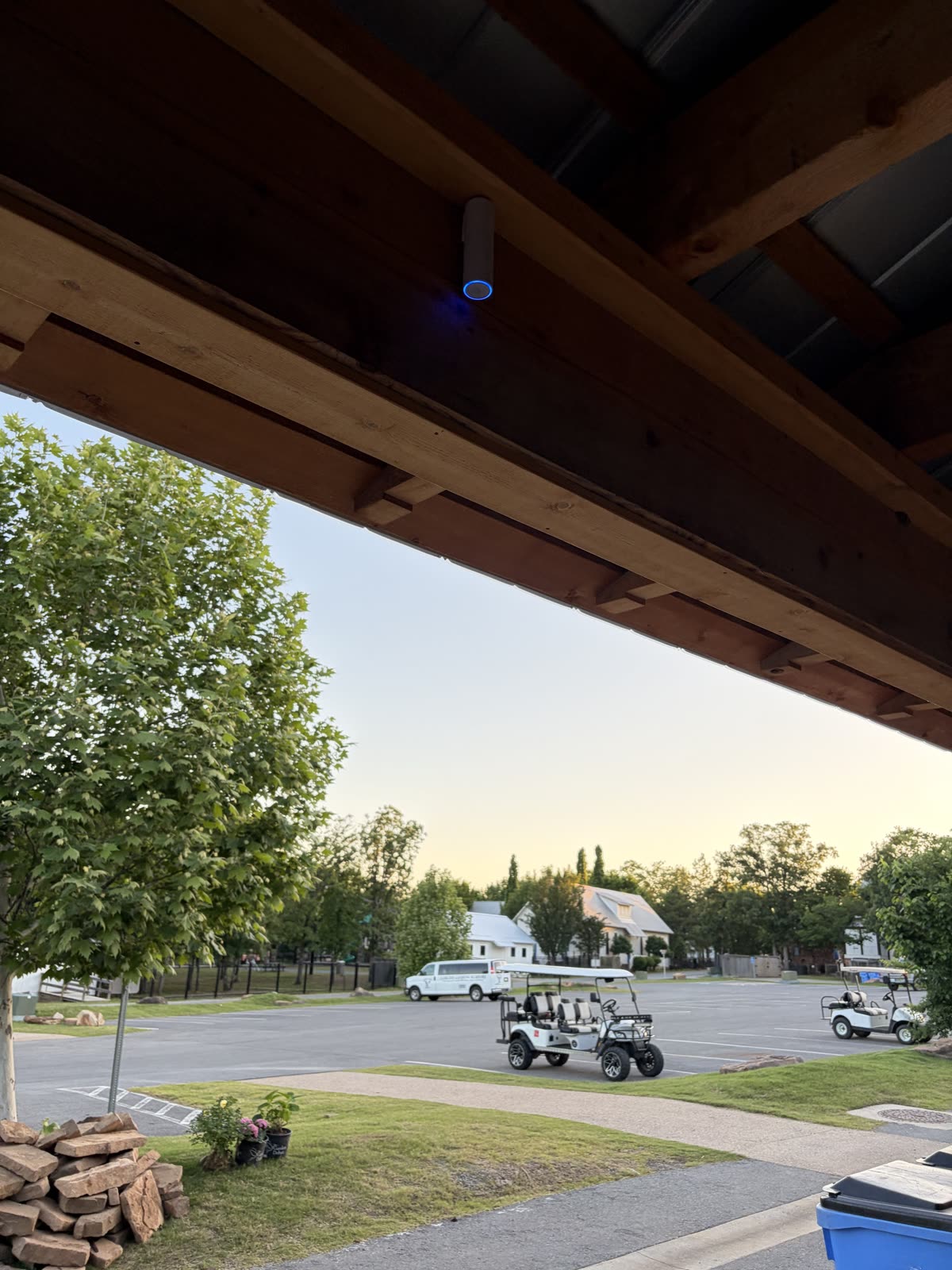 Finished bullet camera mounted under a porch beam