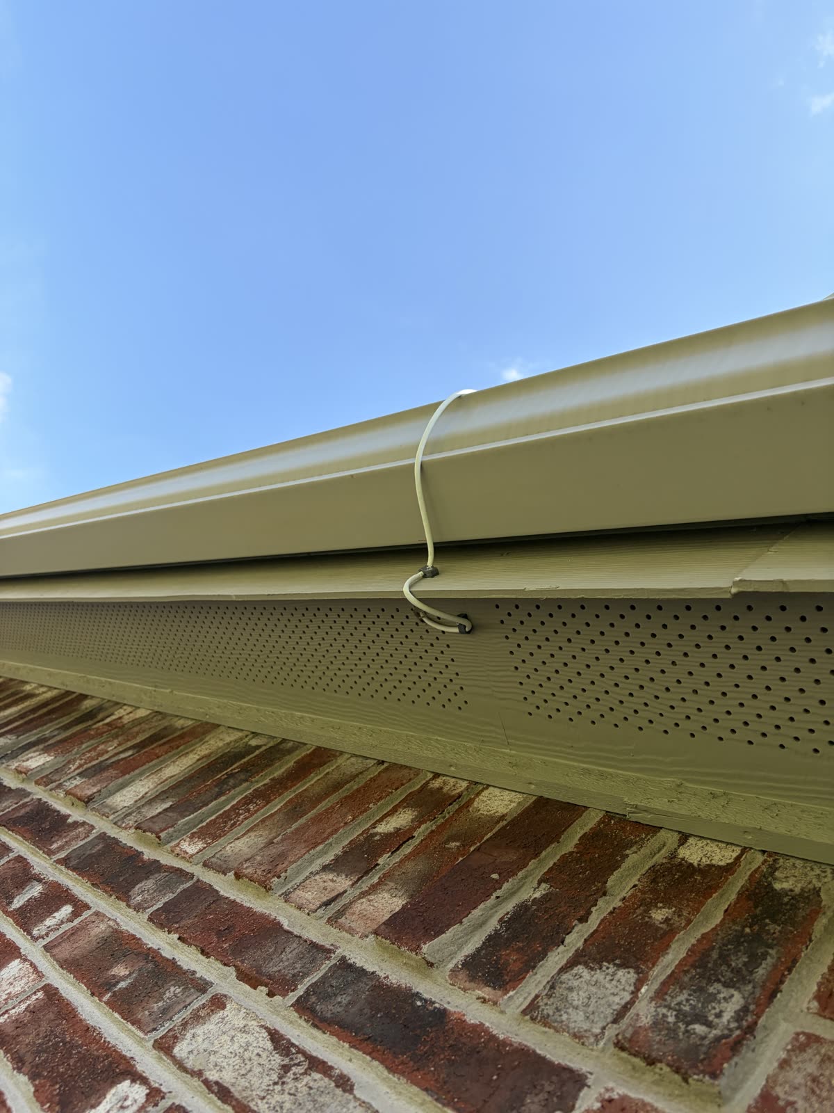 Starlink cable drop through a gutter and soffit with a drip loop
