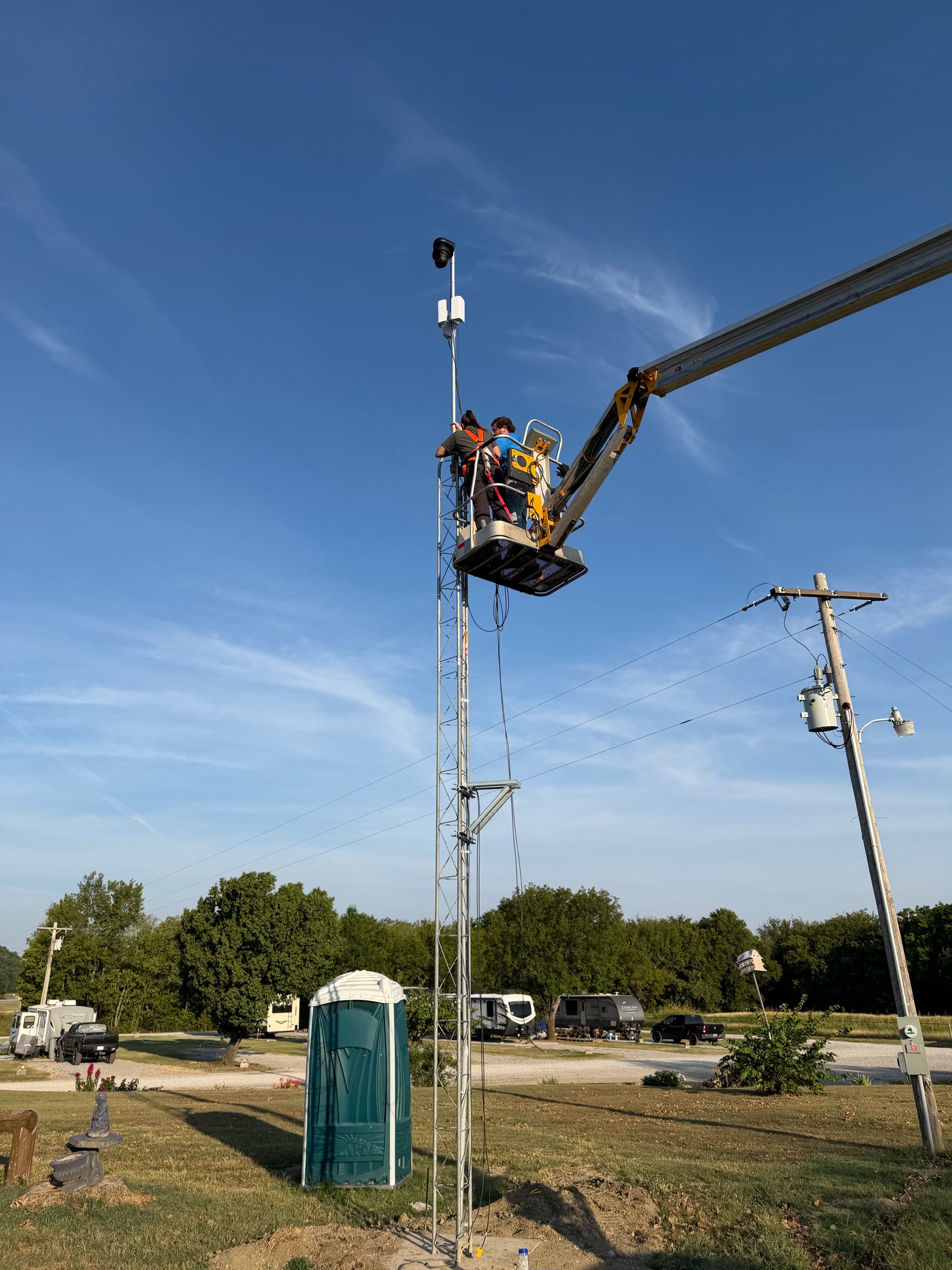 Point-to-point radio and PTZ camera on a lattice tower at an RV park in Claremore